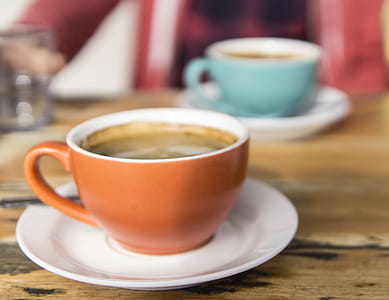 Shallow Focus Photo of Orange Ceramic Mug on White Saucer thumbnail