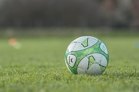selective focus photography of a green soccer ball thumbnail