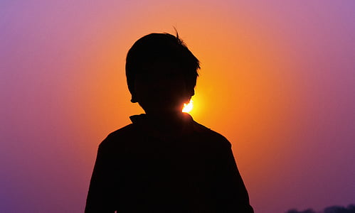 silhouette of boy during golden hour thumbnail