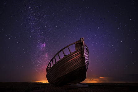 brown wooden boat on seashore thumbnail