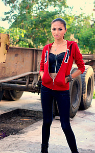 woman wearing jacket beside truck trailer during daytime thumbnail