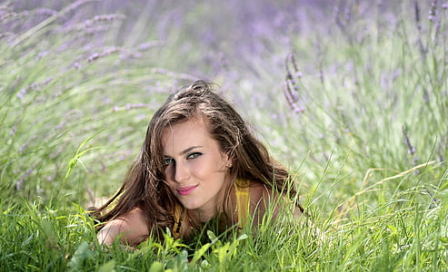 woman in yellow top lying on grassfield thumbnail