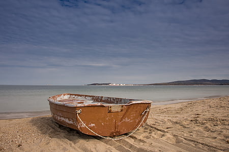 brown jon boat near beach during daytime thumbnail