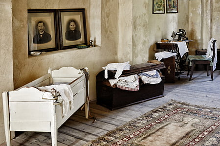 white crib beside black wooden chest thumbnail