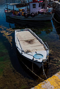empty white motorboat near another boat thumbnail