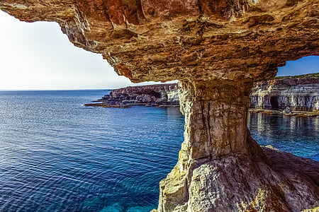 rock formation near body of water thumbnail
