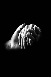 grayscale photo of two hands holding each other thumbnail