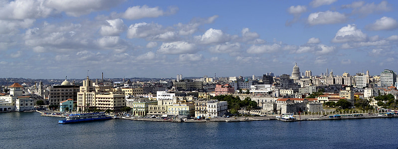 photo of concrete buildings near body of water thumbnail