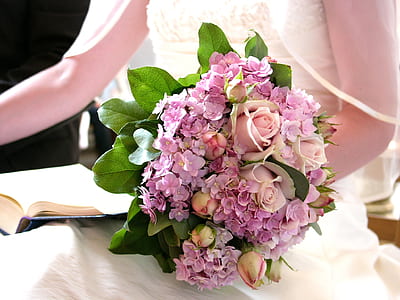 woman holding pink and purple petaled flowers bouquet thumbnail