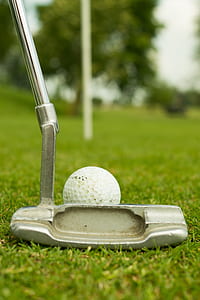 selective focus photography gray golf putter near white golf ball thumbnail