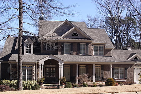 grey and brown 2-storey house near tree during clear blue sky thumbnail