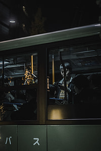 painting of man inside train holding smartphone hanged on wall thumbnail