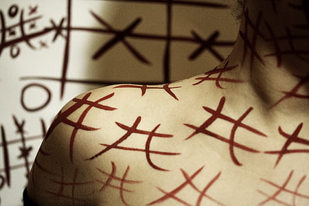 person with numerical sign text on arm thumbnail