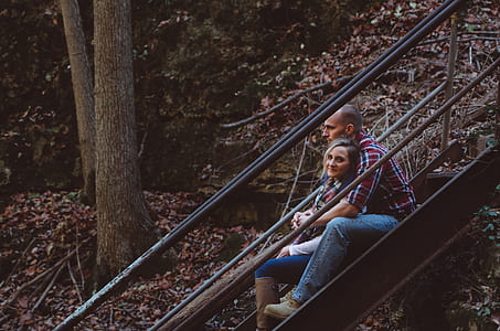 woman and man sitting on stairs hugging thumbnail