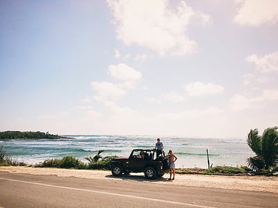 two man on Jeep Wrangler on roadside near body of water thumbnail