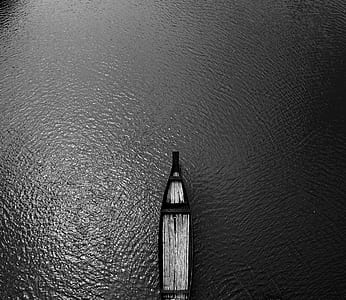 Aerial View Black Wooden Row Boat on Body of Water thumbnail