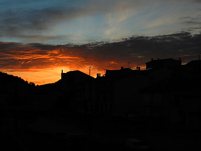 silhouette of houses under sunset thumbnail