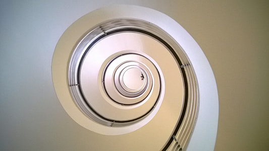 bottom view of white concrete spiral staircase thumbnail