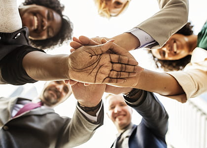 five person formed circle while hands overlap on each other thumbnail