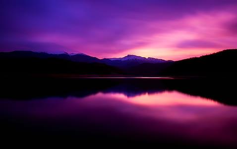 landscape photography of lake under purple sky during daytime thumbnail