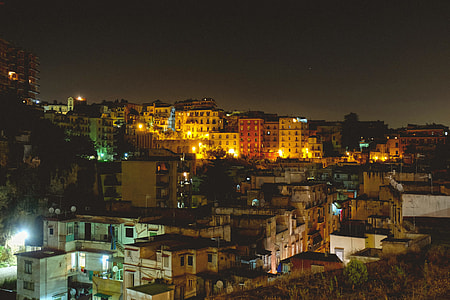 white concrete buildings at night time thumbnail