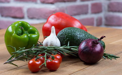tomatoes, onions, garlic, chili, and avocado on wooden table thumbnail
