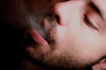 man blowing smoke thumbnail