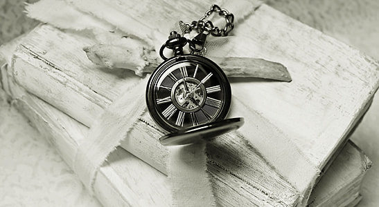 grayscale photography of pocket watch on books thumbnail