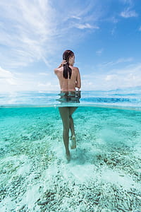 woman standing in body of water thumbnail