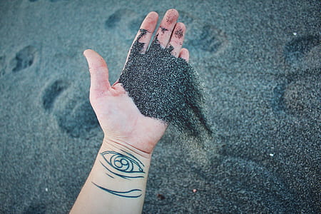 person holding gray sand thumbnail