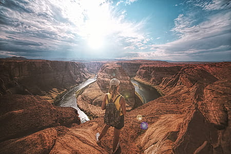 woman standing on cliff near grand canyon during daytime thumbnail