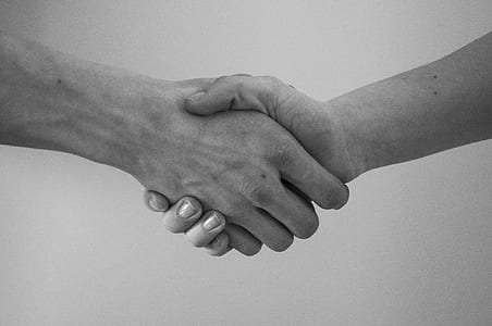 grayscale photo of two person holding hands thumbnail