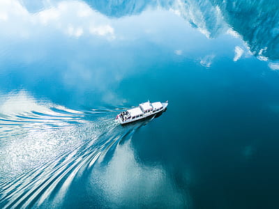 white ship sailing on body of water thumbnail