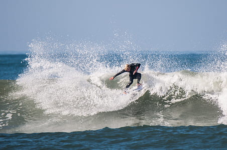 timelapse photo of person surfing on beach wave at daytime thumbnail