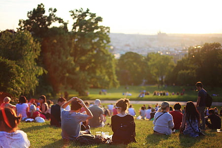 group of people sitting on grass thumbnail