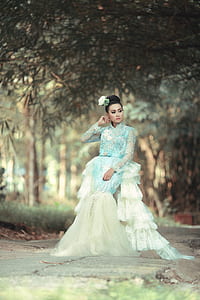 woman wearing green and white lace long dress standing on gray surface thumbnail