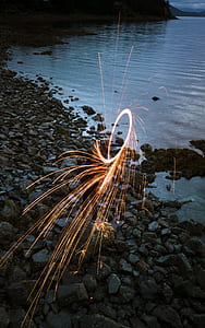 wool photography of a man standing on rock seashore thumbnail
