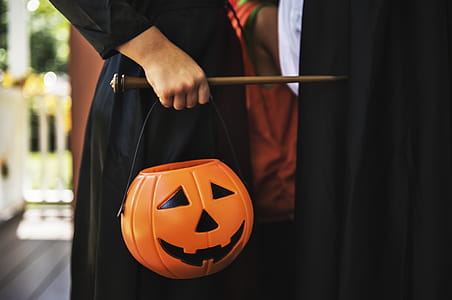 Photo of Person Holding Jack O' Lantern Bucket thumbnail