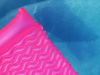 pink inflatable pool float inside a pool thumbnail