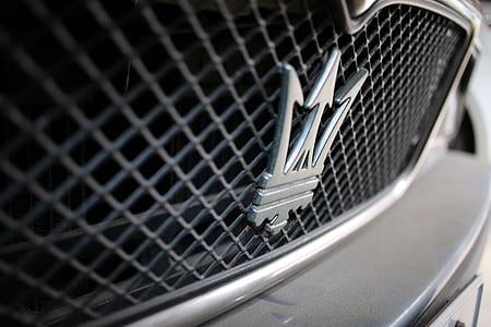 close-up photography of Maserati emblem on car thumbnail
