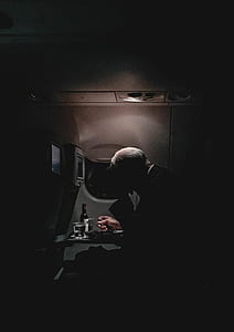 man sitting inside the plane photo thumbnail