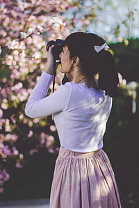 woman taking picture using her black DSLR camera thumbnail