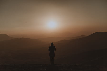 silhouette of woman near mountain range thumbnail