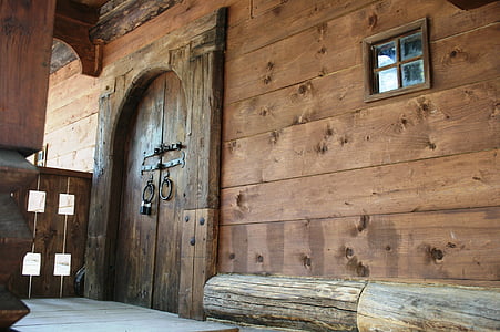 brown wooden house with side-by-side door and door knockers thumbnail