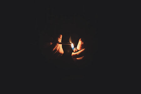person lighting a cigarette stick thumbnail