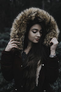 black haired woman wearing brown parka jacket thumbnail