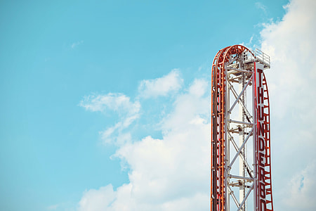 red and white roller coaster during day time thumbnail