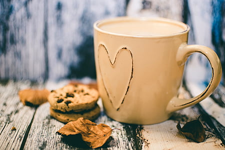 orange heart ceramic mug near cookies thumbnail