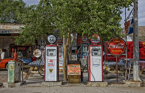 two white-and-red gasoline fuel pump station near tree at daytime thumbnail