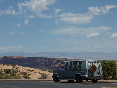 blue van on concrete road near mountain at daytime thumbnail